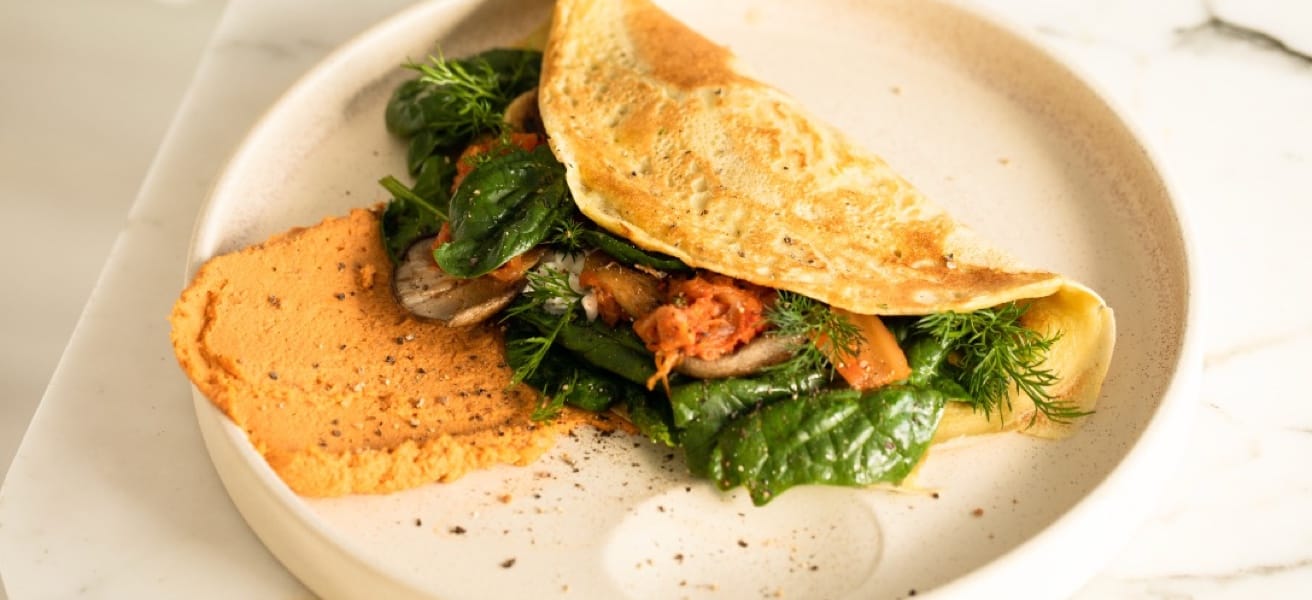 Omelette with salad on a plate in a pleasing composition